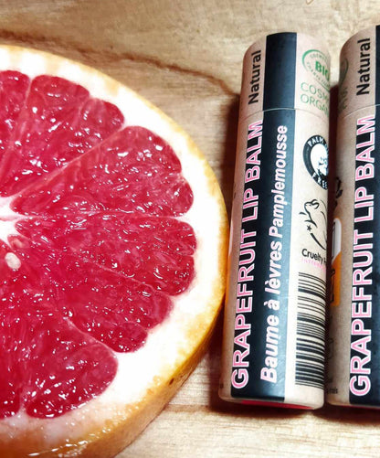 EARTH SENSE ORGANICS LIPPENBALSAM GRAPEFRUIT 15ml - 2 Lippenbalsam neben frischer Grapefruit Scheibe
